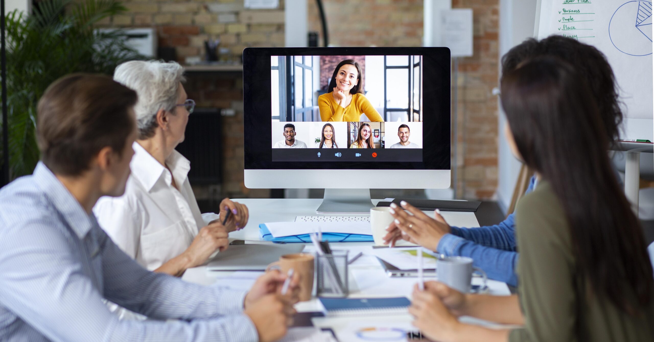 A group of coworkers using one of the best video conferencing systems for business